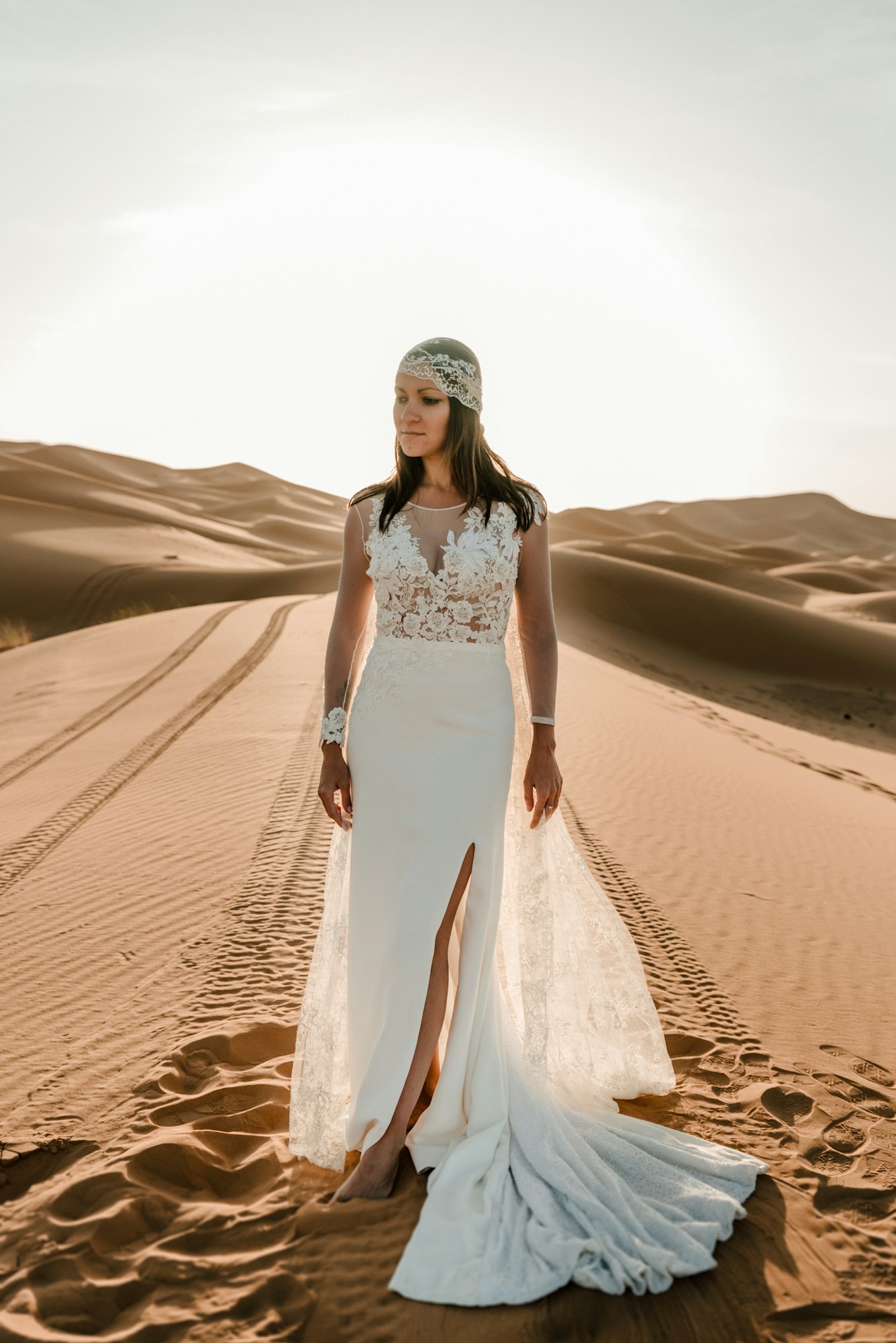 A woman in a wedding dress in the desert